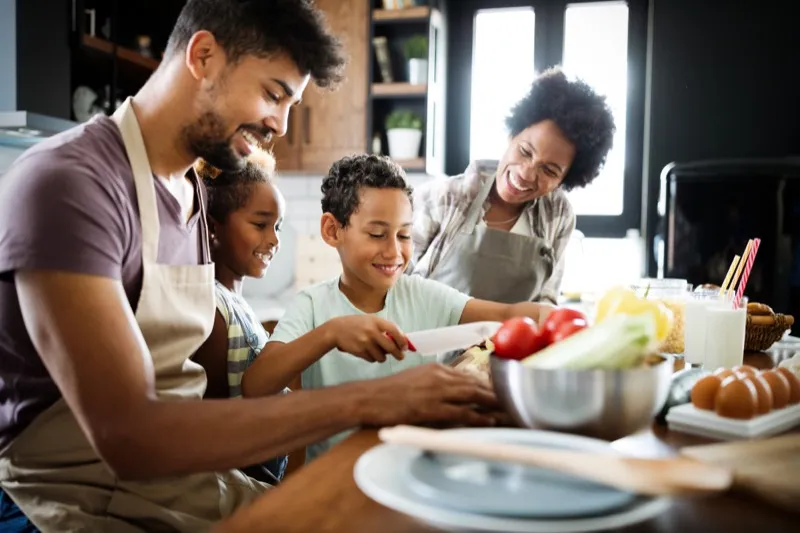 A happy family who is preparing food together